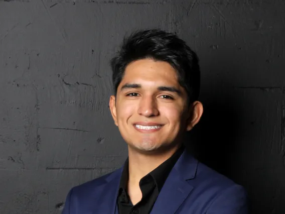 man wearing a dark suit smiling