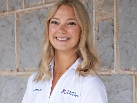 woman wearing a white polo and smiling