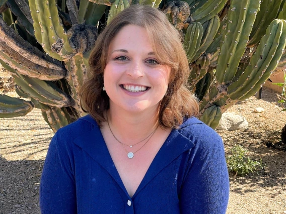 headshot of Nicole in front of a cactus